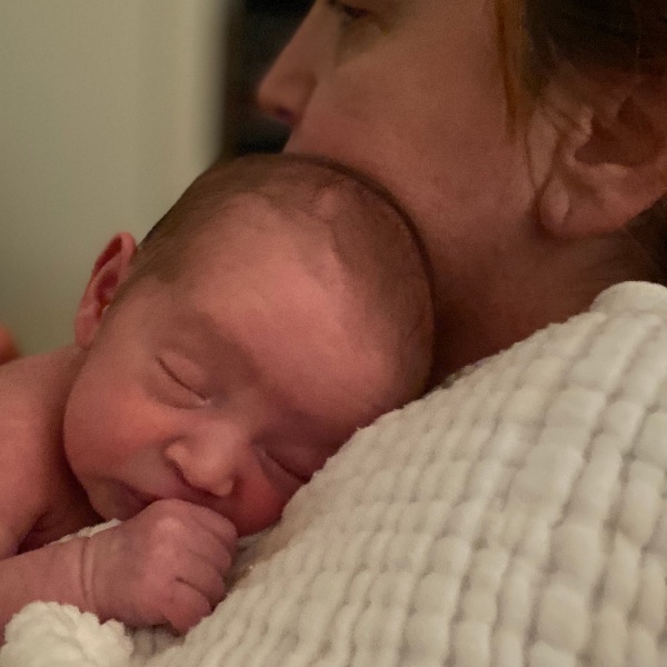 Newborn Alex asleep on his mother's chest.